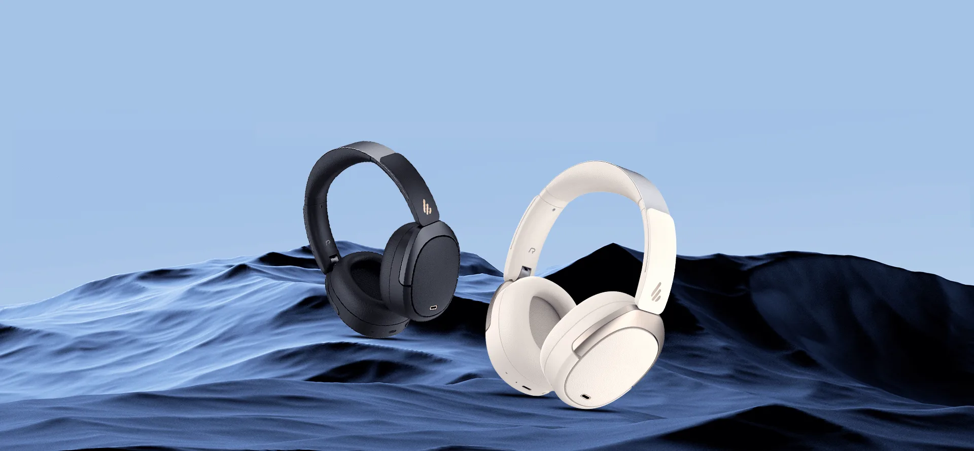 Edifier W80 headphones in Black and Ivory side by side over a blue wave backdrop